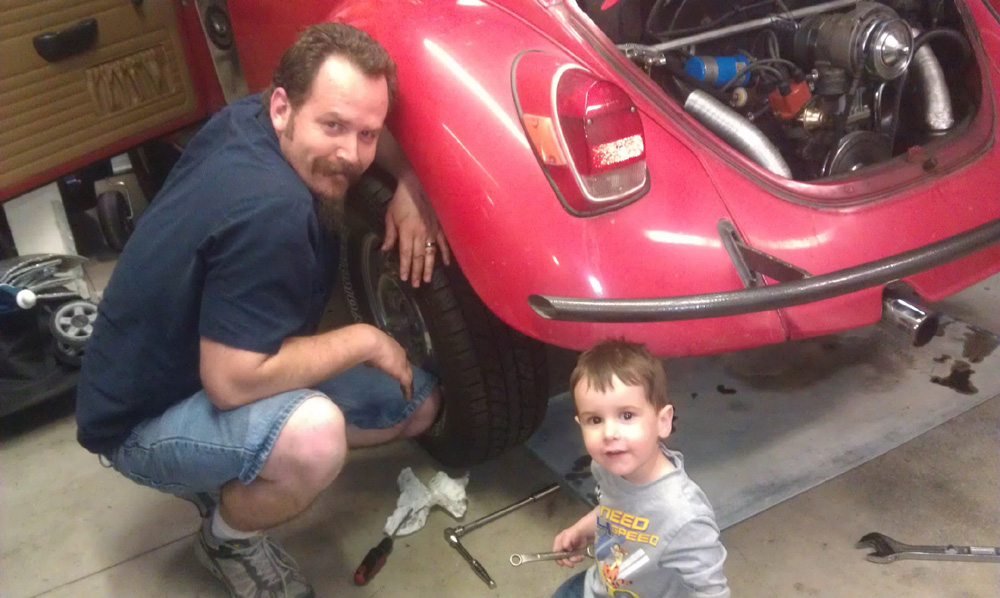 Standard VW Beetle with owner and son