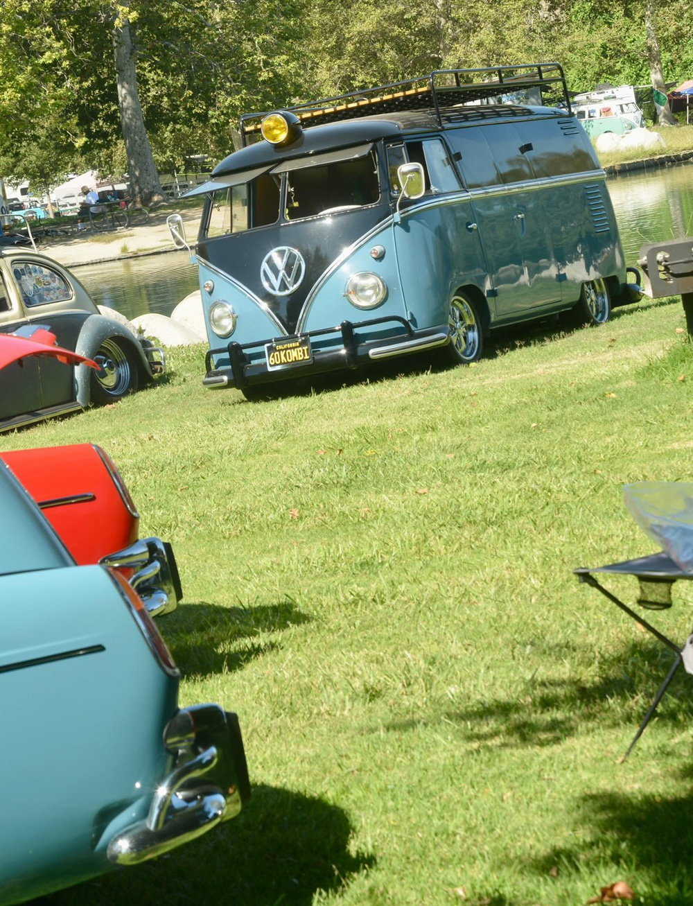 Two tone Volkswagen Kombi parked by the pond with two Type 3 VWs in the foreground at the El Prado VW Show & Shine