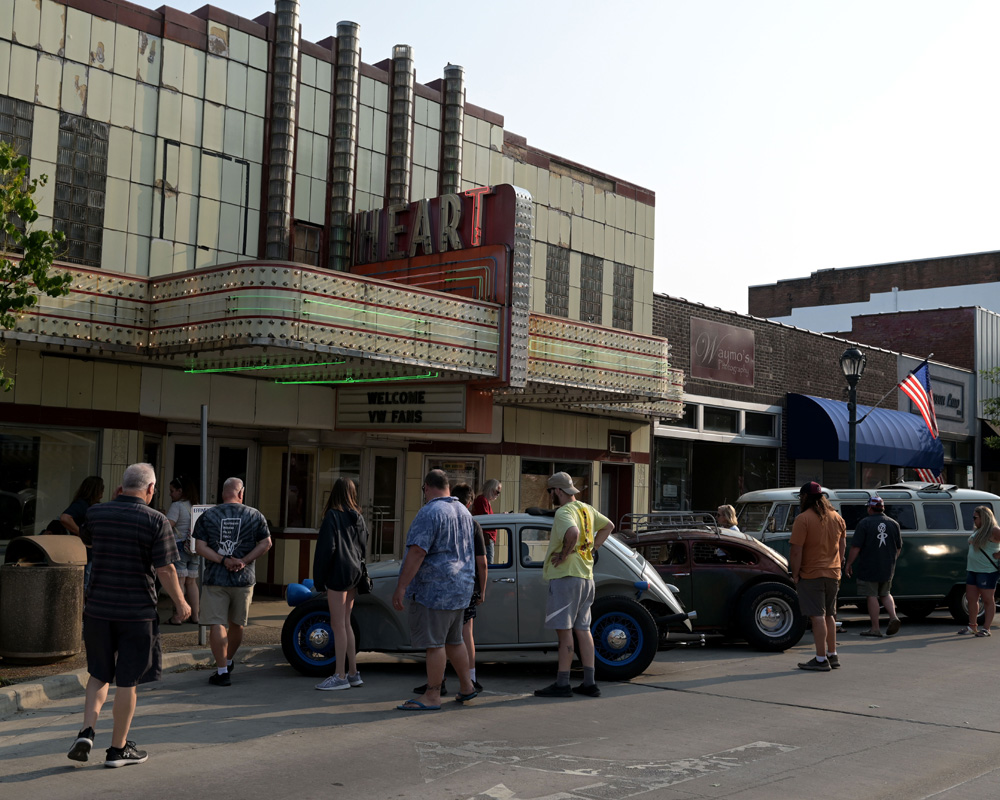 Volkswagen cars lined up in front of the Heart Theater during a Funfest community event