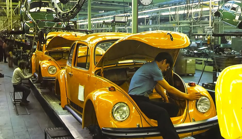 A colourful scene with two special limited edition Jeans Beetles in the final assembly hall of either Volkswagen Wolfsburg, or possibly at Volkswagen Brussels which were the two factories that produced this edition for the 1974 model year